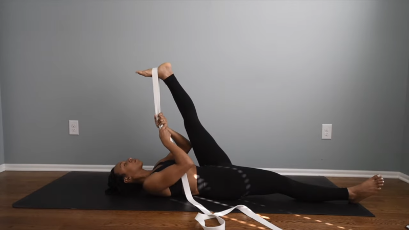 A Woman Using a Flymall Yoga Strap