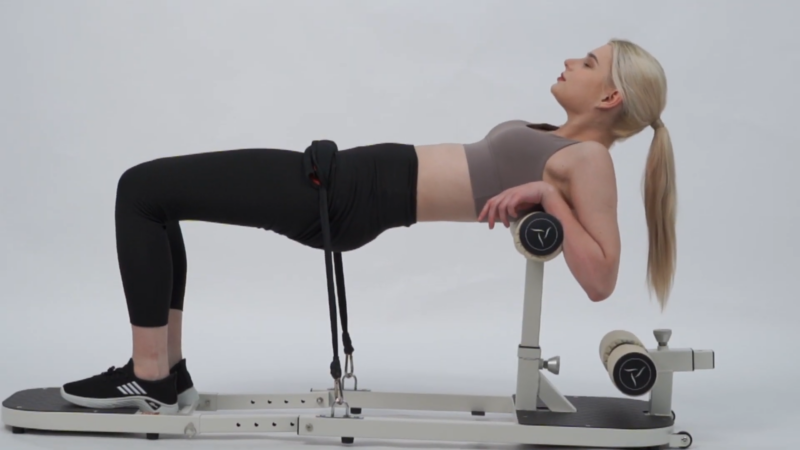 A Woman Using the Seanleecore Squat Machine