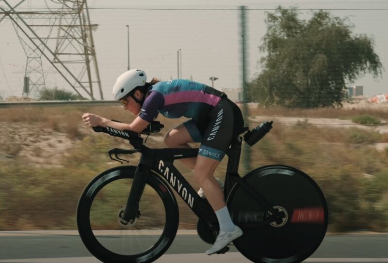 Cyclist in a racing position on aerodynamic bike