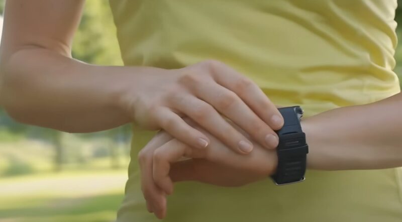 Runner in yellow shirt checking his watch