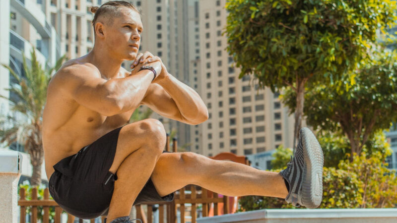 Guy doing squat exercise in an outdoor setting