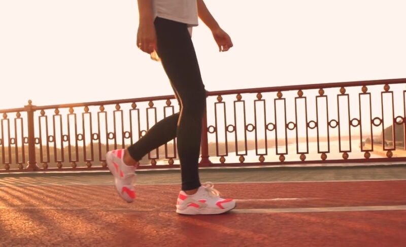 A person walking on a bridge walkway