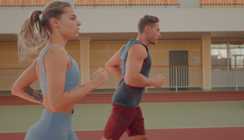 Man and woman running indoors