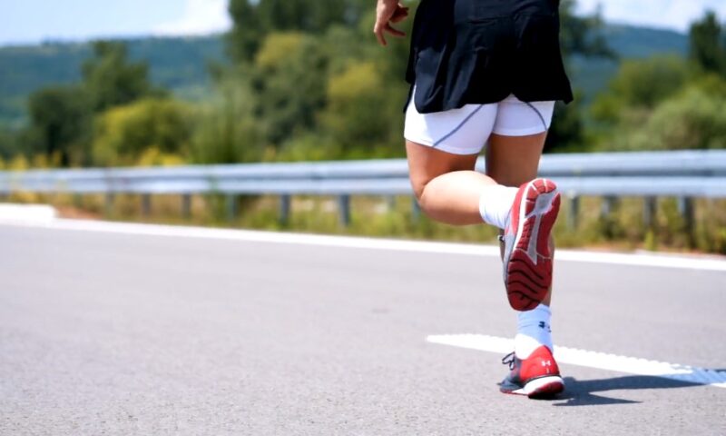 A person running on a paved road