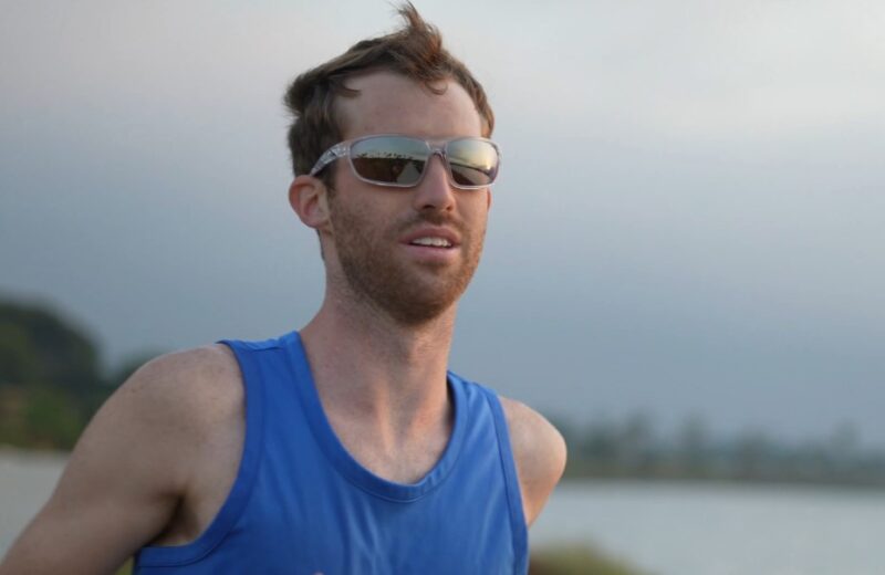 Male runner in blue top wearing sunglasses