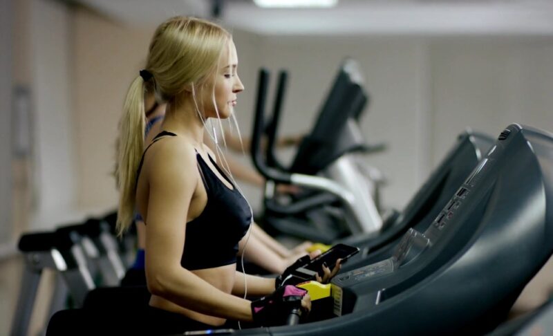 Girl listening to music while on a treadmill