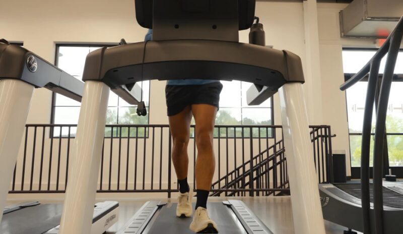 A person walking on a treadmill in a gym