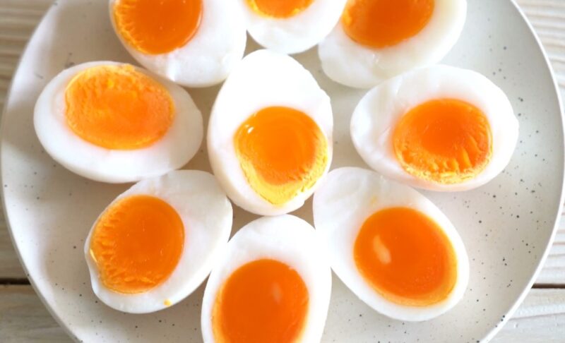 Perfectly cooked, halved eggs, showcasing vibrant yolks