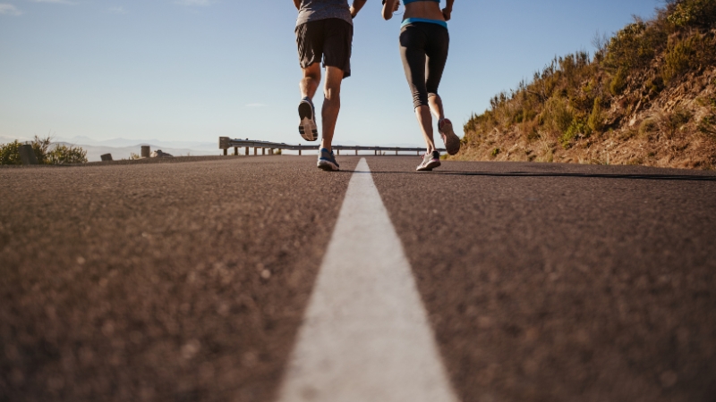 A Couple Running Together on A Road, Highlighting the Importance of Self-Care Tips for Runners