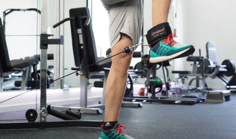 Close-up view of a person's leg and foot during a leg exercise