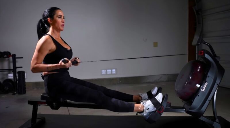 Woman intensely using a rowing machine