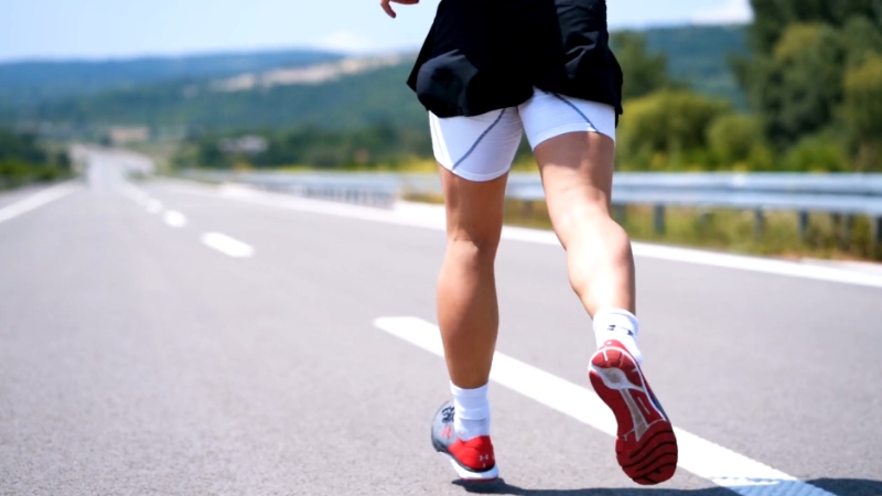 A runner showing proper form and stride, benefiting from a strong posterior chain