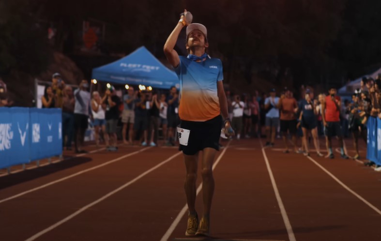 Hayden Hawks, a runner, crosses the finish line
