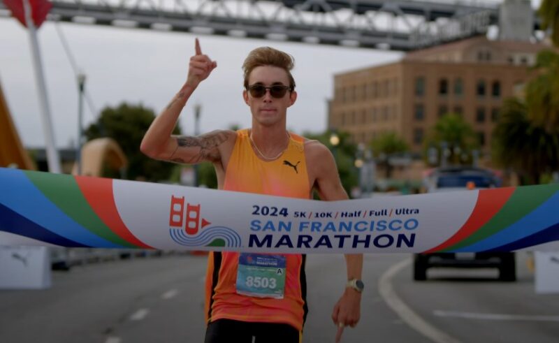 A runner crosses the finish line of the 2024 San Francisco Marathon