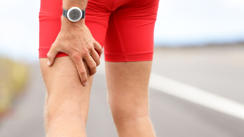 A runner performing an exercise related to hamstring rehab