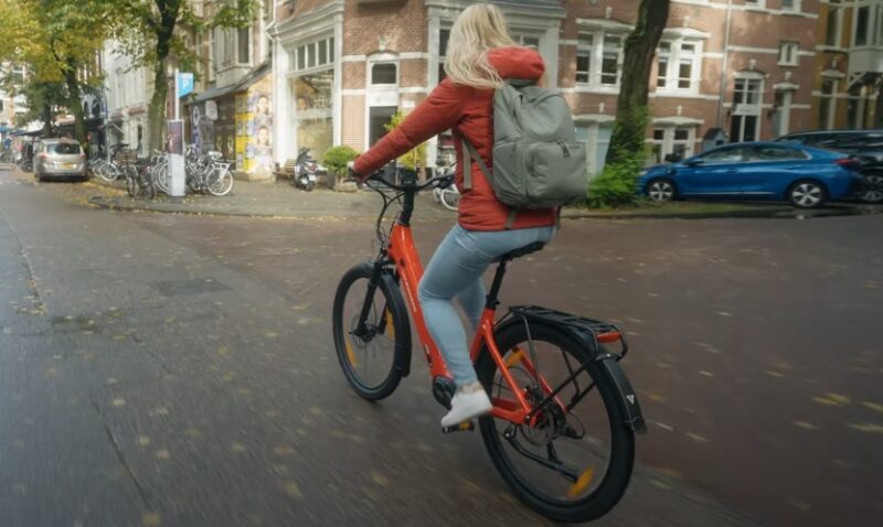 Woman on a bike navigating a city street