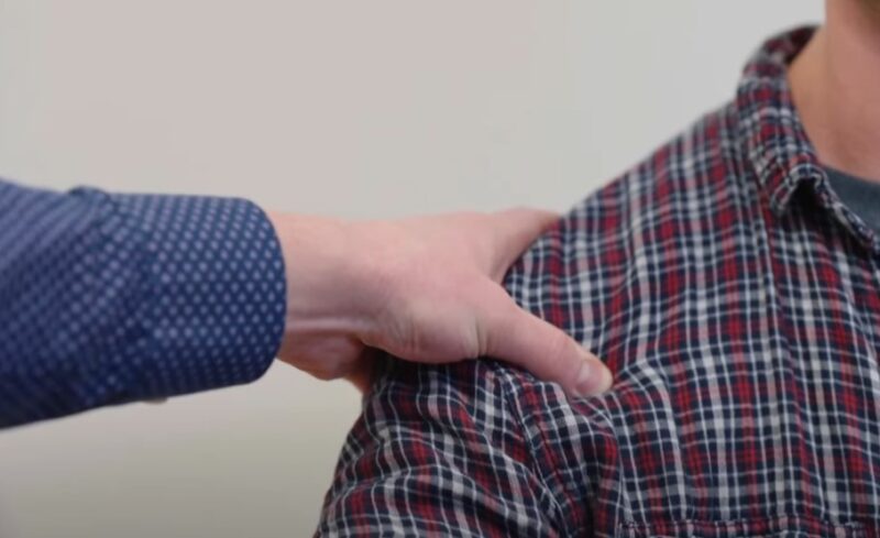 A hand placed on the shoulder