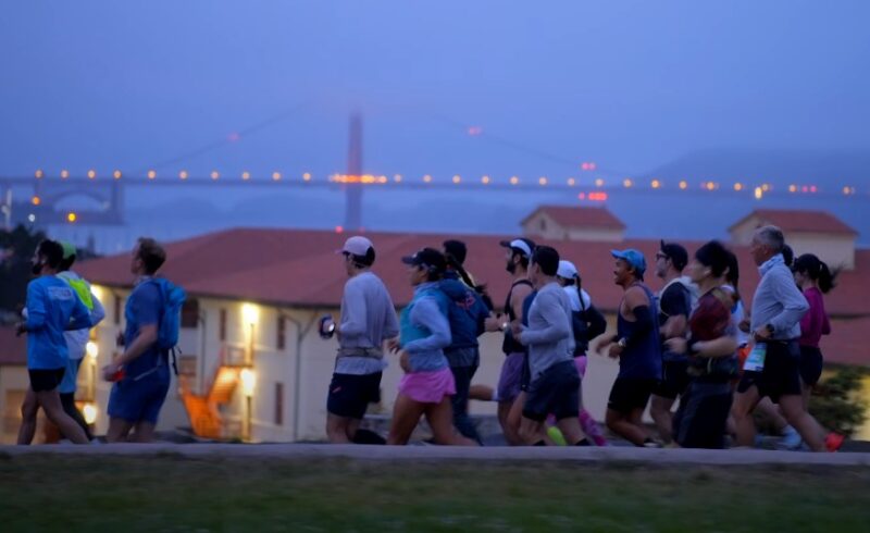 Runners navigate a scenic route, the Golden Gate Bridge a backdrop to their determined strides