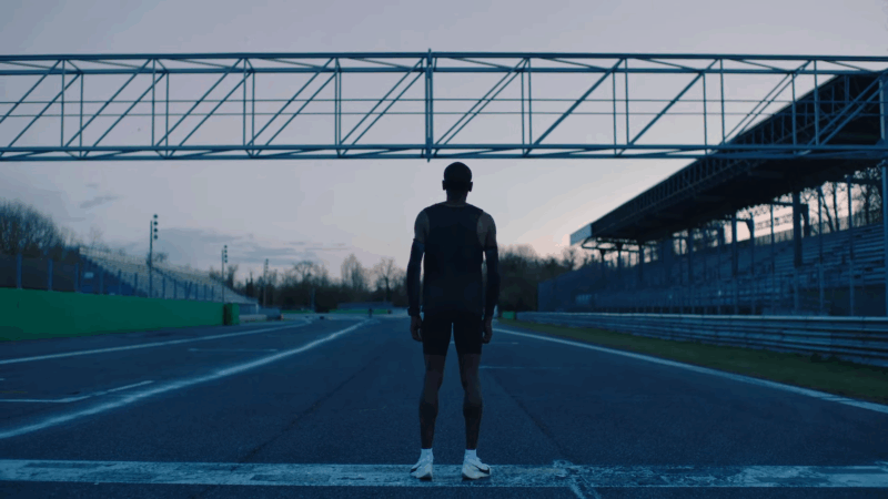 A runner stands on a track at dawn before the sub-2-hour marathon attempt