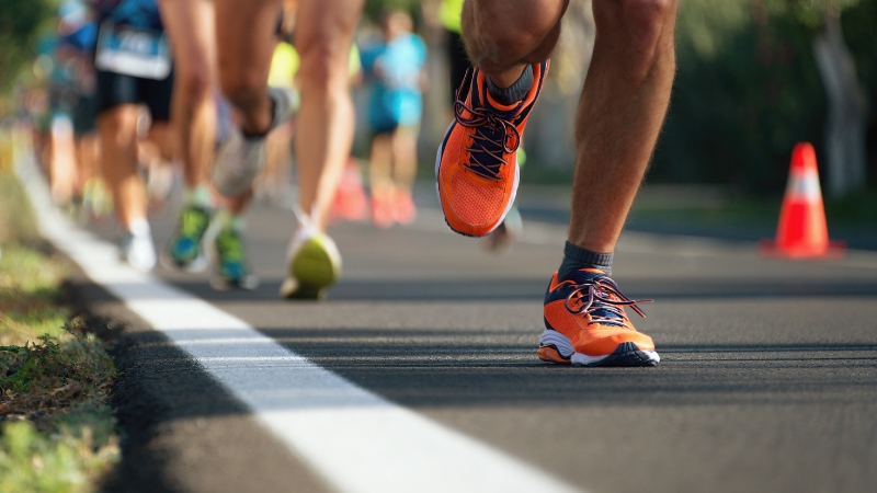 Runners on a road following a half marathon training plan