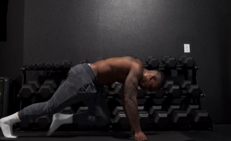 Athlete performing a challenging variation of a plank