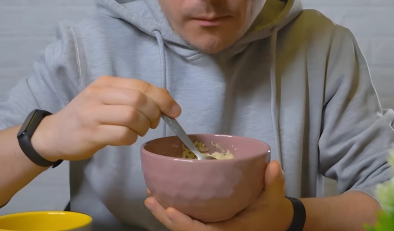 A close-up view of someone eating instant noodles