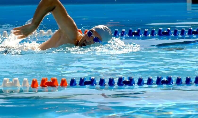 A swimmer glides effortlessly through the azure water