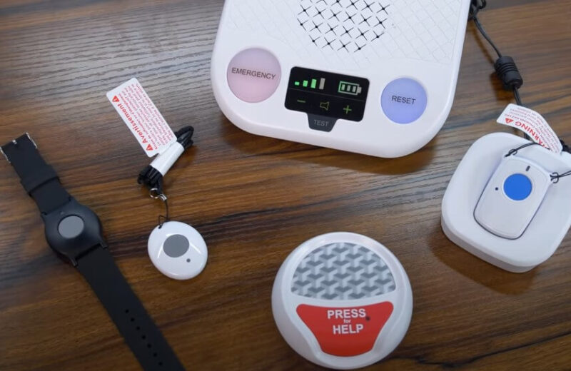 A personal emergency response system, featuring a wristband, pendant, and base unit