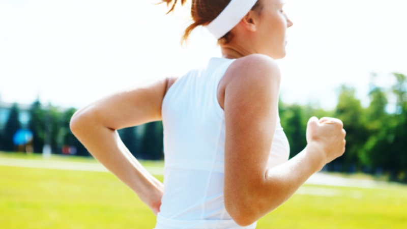 Woman running outside in bright daylight