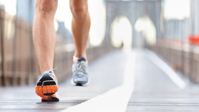 Runner’s legs on a bridge during week 6 of a half marathon training plan
