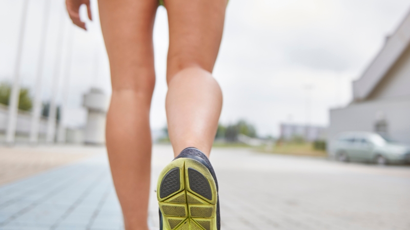 Runner’s feet moving forward outside