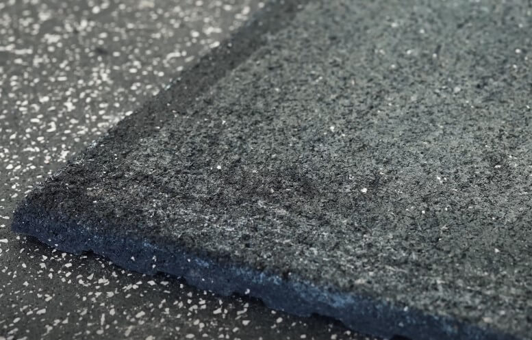 Close-up view of a dark gray rubberized flooring tile