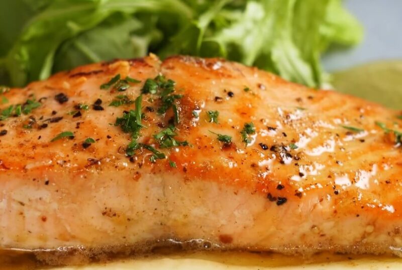 Perfectly seared salmon, glistening with a flavorful sauce