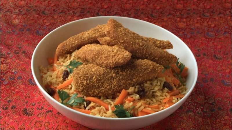 Bowl of rice with vegetables and breaded chicken, representing right nutrition for muscle repair