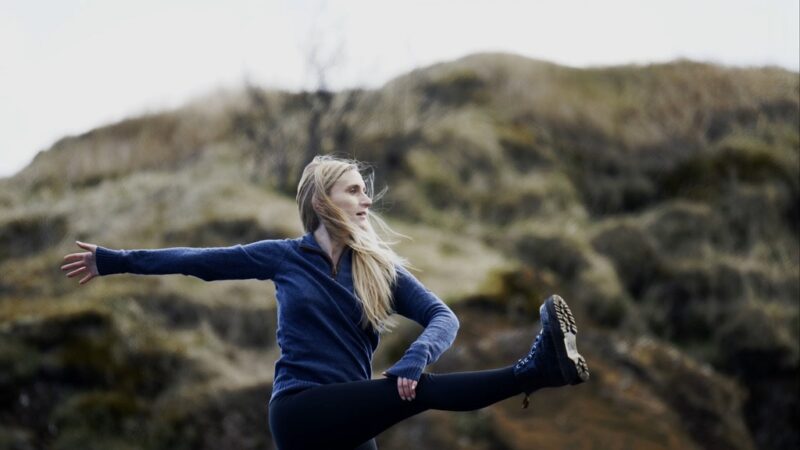 Woman practicing Tai Chi outdoors for balance, relaxation, and flexibility