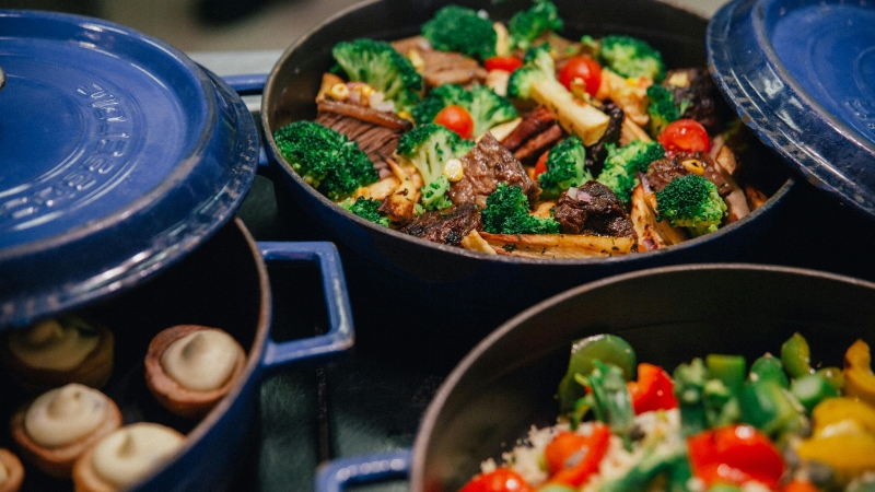 A pot filled with beef, broccoli, and roasted vegetables that may feel too heavy before a workout