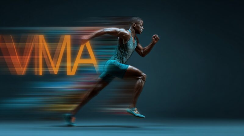 A male athlete sprinting at full speed with the letters “VMA” trailing behind in motion blur, symbolizing velocity and performance