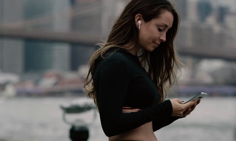 Woman checking fitness app during run workout